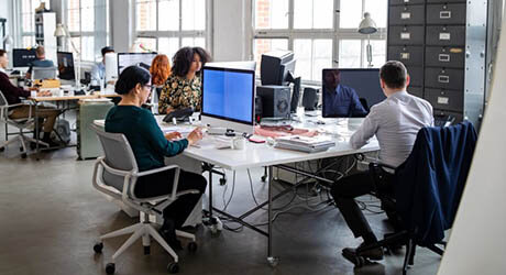 Menschen in einem Startup-Büro nutzen schnelles Glasfaser bei der Arbeit.