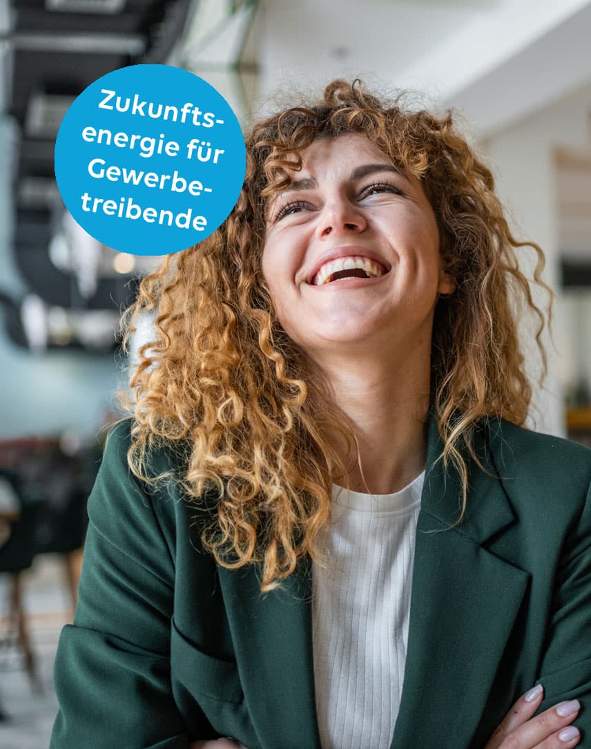 Eine Frau in grünem Oberteil verschränkt die Arme und lacht, darüber ein Text: Zukunftsenergie für Gewerbetreibende