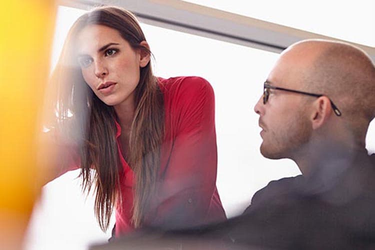 Eine Frau und ein Mann prüfen etwas an einem Arbeitsplatz