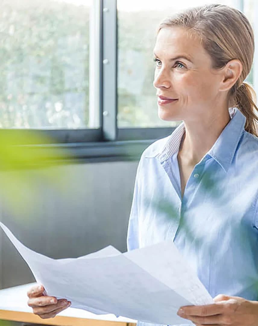 Frau im Business-Look mit Zetteln in der Hand