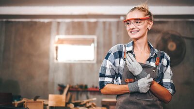 Freundliche Handwerkerin in Werkstatt