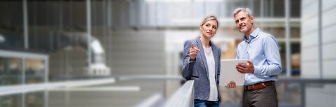 Chefsache: grüne Lösungen mit EWE business Eine Frau und ein Mann mit Tablet in einer Werkshalle