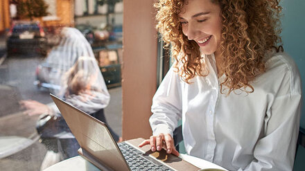 WLAN-Hotspot von EWE Frau im Café am Laptop