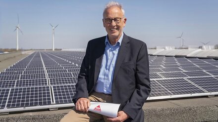 EWE business Referenz Hase Mann mit Brille vor PV-Anlage