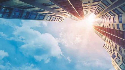 Wohnungswirtschaft Ein hohes Gebäude von unten nach oben fotografiert